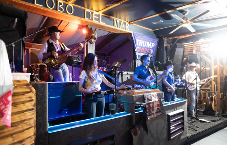 A band playing on stage at the bar