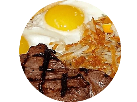 A plate of food with steak, eggs and hash browns.