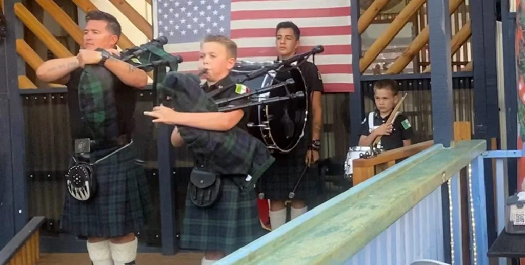 A group of people in kilts playing music.